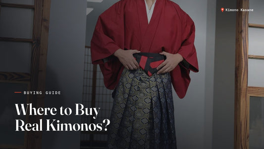 Man wearing an authentic red kimono with patterned hakama pants in a traditional Japanese interior, illustrating where to buy authentic kimonos in the US