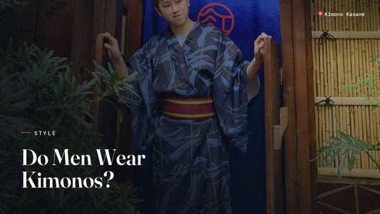 Man wearing a blue men's kimono (yukata) with a red obi belt standing in a traditional Japanese doorway