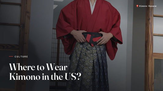 Man wearing a red kimono and patterned hakama at a traditional Japanese venue, ideal attire for kimono events and festivals in the US